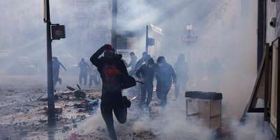 Manifestante corre durante uma manifestação contra o alto custo de vida, em Paris, neste sábado (17), no âmbito de uma convocação nacional que reuniu diferentes grupos mobilizados pelo descontentamento social, entre eles ex-integrantes dos coletes amarelos, estudantes do ensino médio e universitários, ativistas ambientais e agricultores. Foto: AFP - KIRAN RIDLEY / RFI